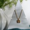 gold toned necklace with pendant